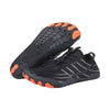 EcoStep wide foot barefoot shoes in black with orange toe pods, pair with one shoe showing the flexible sole